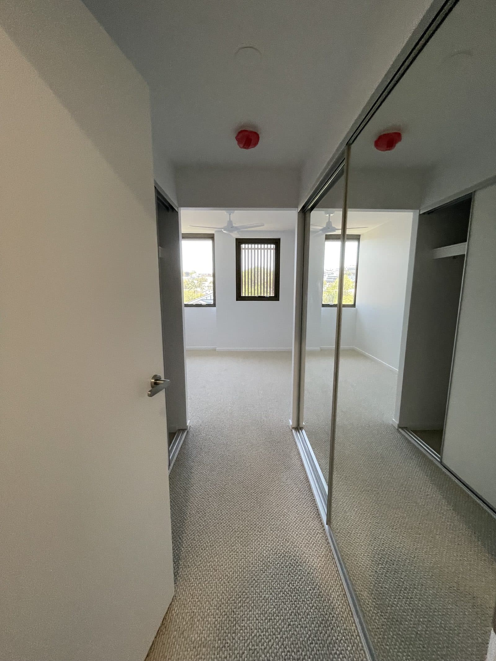 Second bedroom with ceiling fan, mirrored robes and views