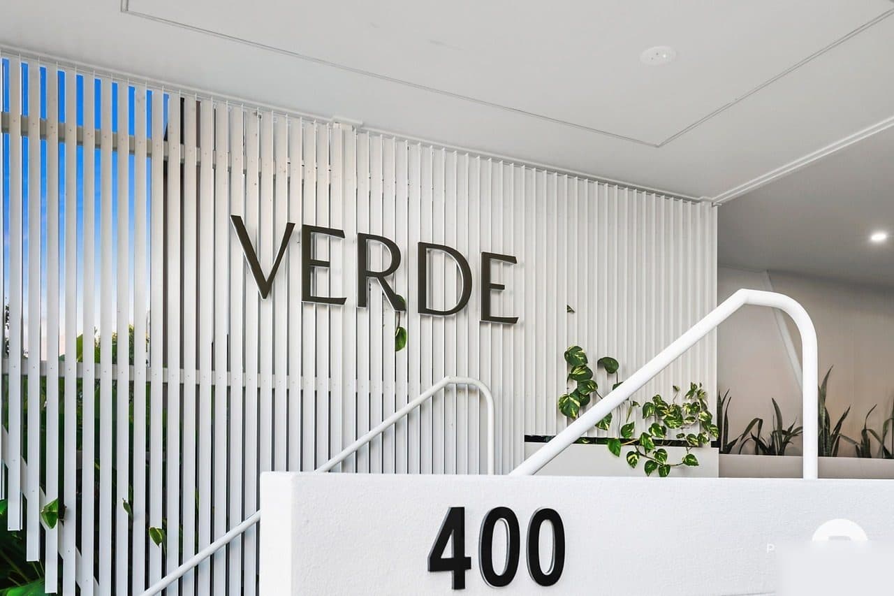 Verde entrance — VERDE signage with white slatted facade
